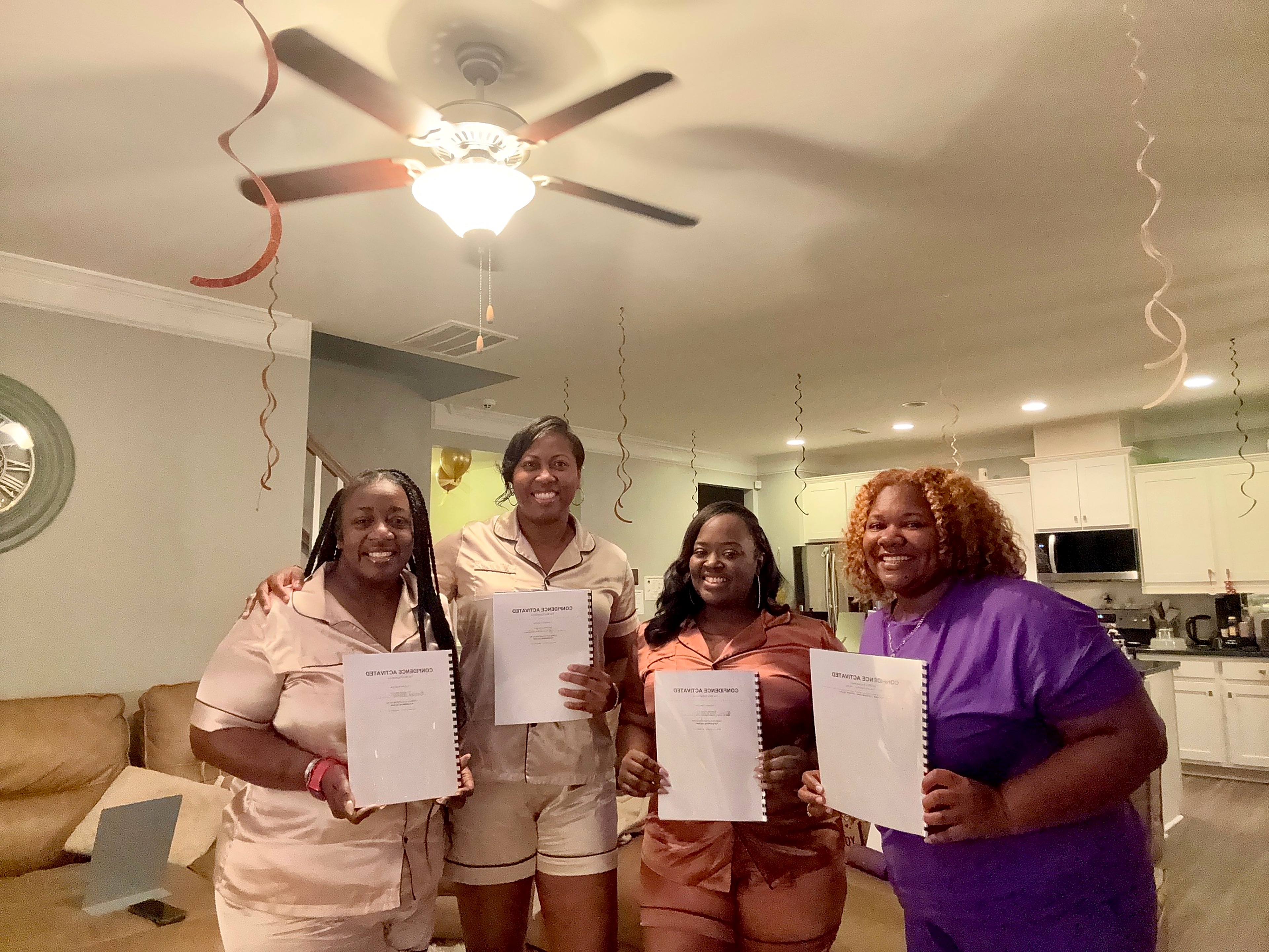 Participants holding their Confidence Activated workbooks