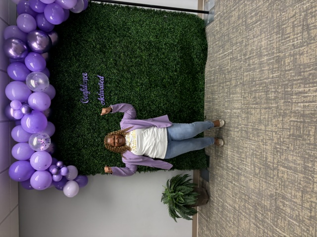Elena celebrating with arms raised at a Confidence Activated event